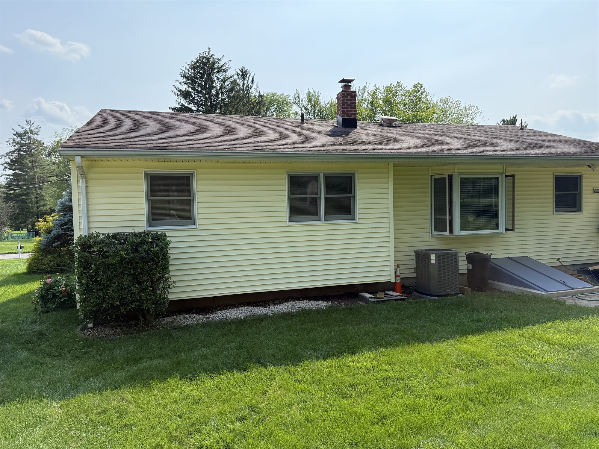 Before: front quarter at the entry, original siding running out to the corner boards