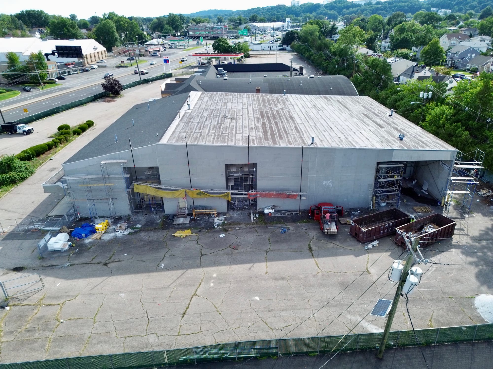 The anchor building from the air, rear elevation stripped back with materials and containers staged in the yard