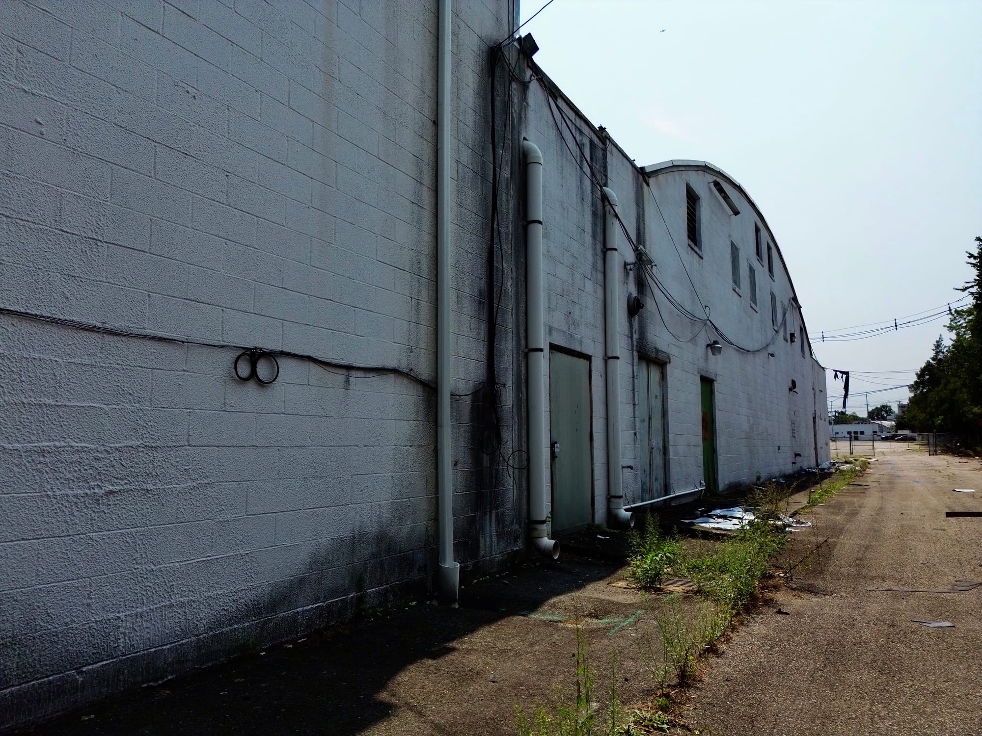 Before, detail: painted masonry on the side elevation showing the condition of the existing finish