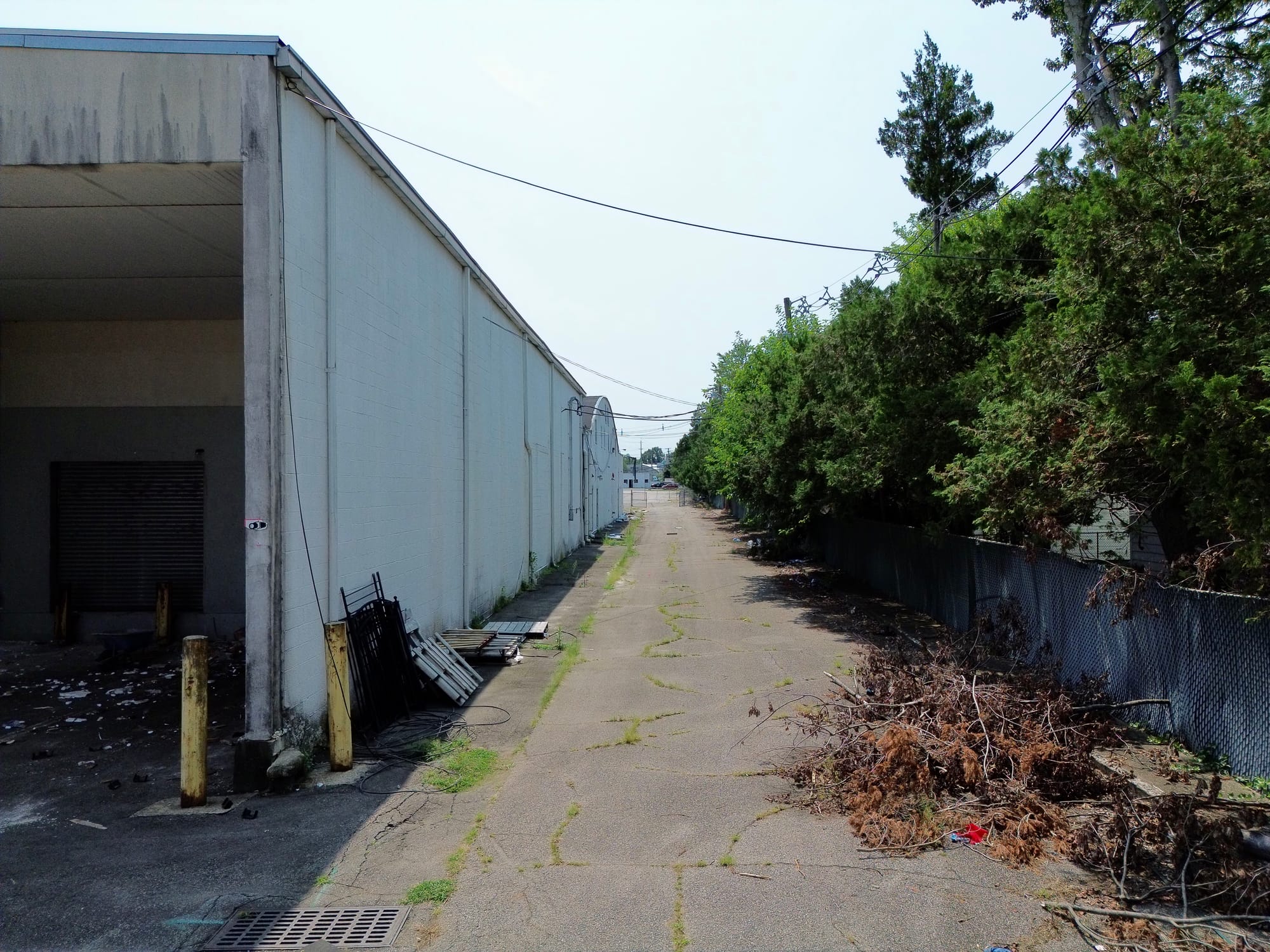 Before: the long side elevation in its existing condition, staining and weathering across the full run