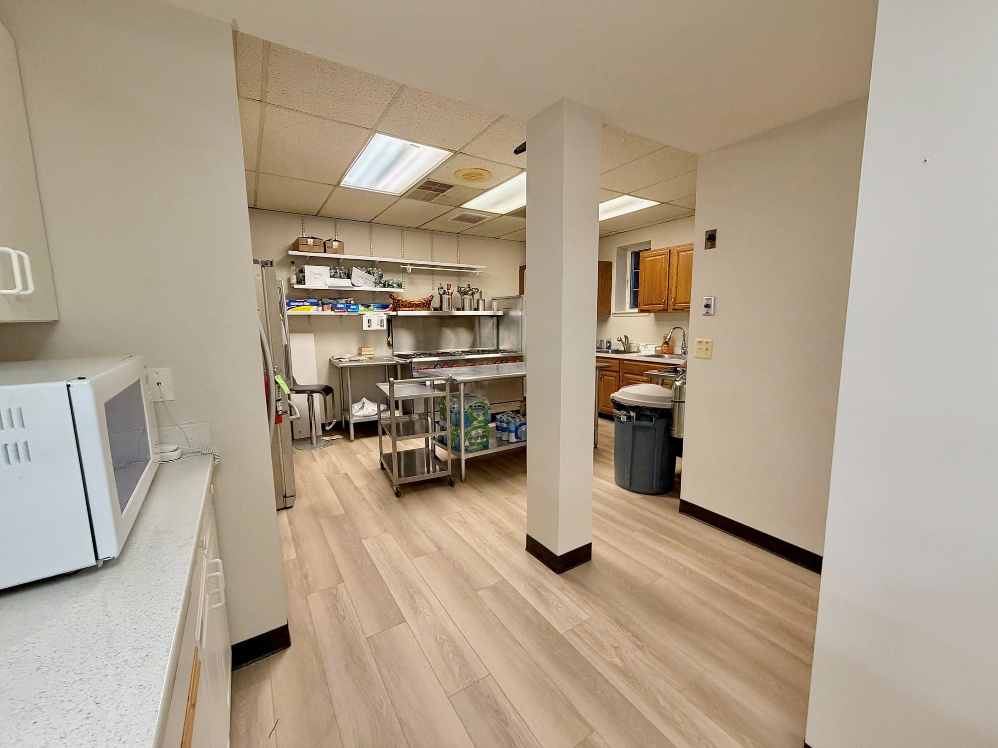 After: new flooring carried through the servery into the commercial kitchen